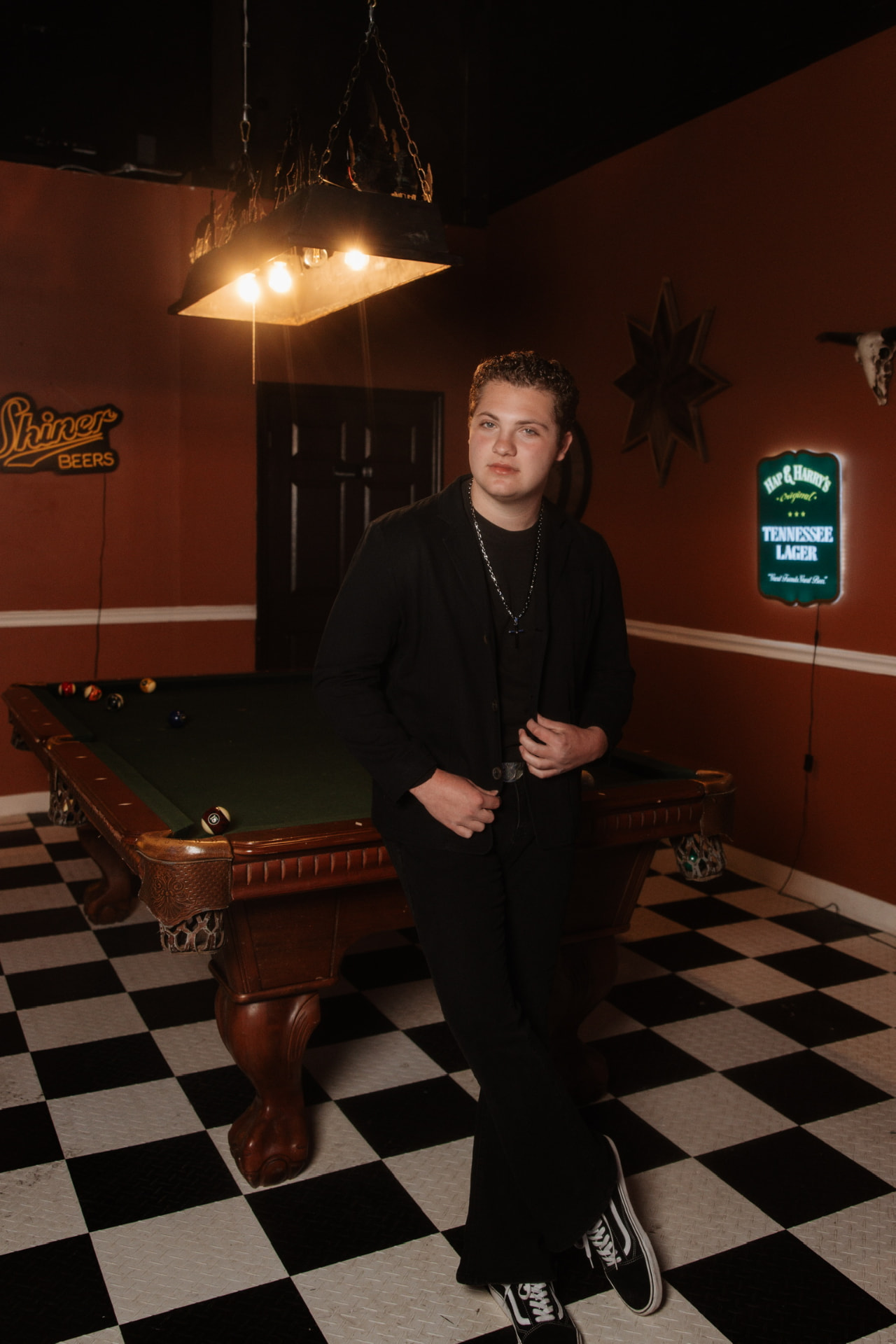 Davey J leaning against a pool table under a hanging lamp