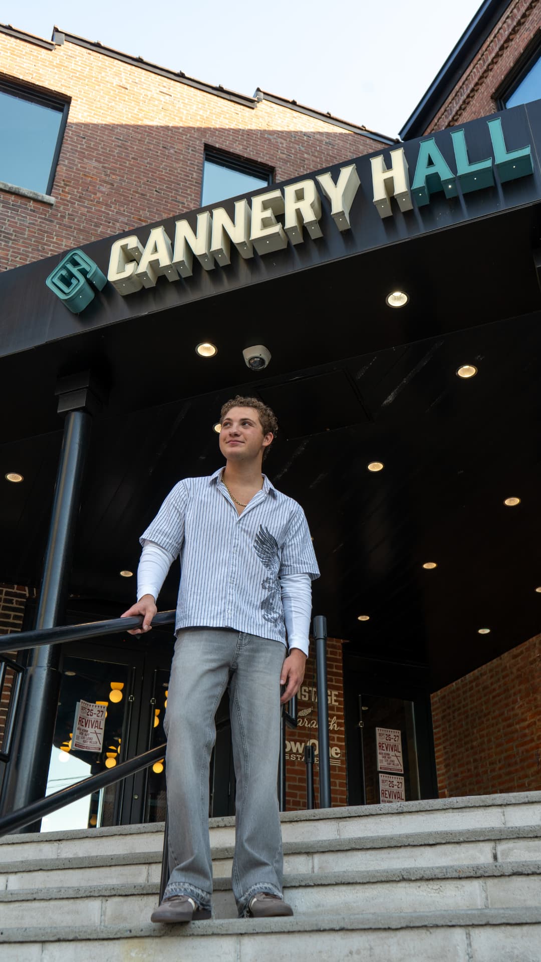 Davey J looking up on the steps outside Cannery Hall